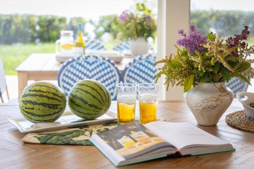 a table with two water melons and two glasses of beer at Stardust by AvantStay Views Hot Tub Pool Table in Malibu