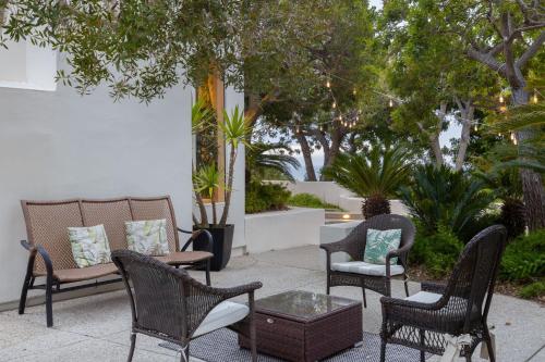 a patio with chairs and a table and trees at Stardust by AvantStay Views Hot Tub Pool Table in Malibu