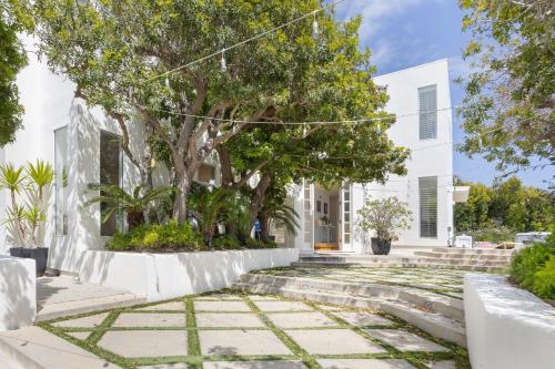 a white house with trees and stairs at Stardust by AvantStay Views Hot Tub Pool Table in Malibu