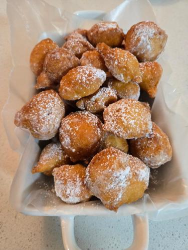 a plate of doughnuts covered in powdered sugar at Serenity Inn in Niagara Falls