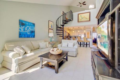 a living room with a couch and a table at 512 Seascape by AvantStay Oceanfront Condo on the Beach Community Pool Access in Isle of Palms