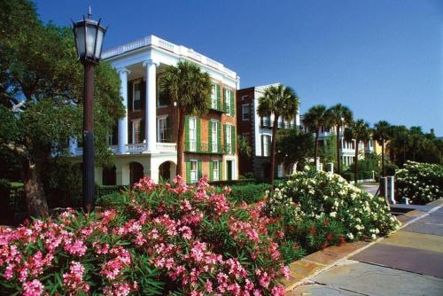 a building with a street light and flowers in front of it at 512 Seascape by AvantStay Oceanfront Condo on the Beach Community Pool Access in Isle of Palms