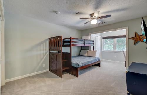 a bedroom with a bunk bed and a ceiling fan at 11 43rd Avenue by AvantStay Pool Close to Beach in Isle of Palms
