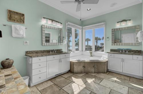 a bathroom with two sinks and a large window at 502 Ocean Blvd by AvantStay Beachfront w Pool Ocean Views in Mount Pleasant