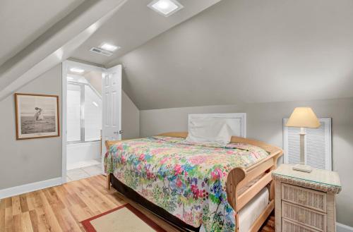 a bedroom with a bed with a colorful bedspread at 502 Ocean Blvd by AvantStay Beachfront w Pool Ocean Views in Mount Pleasant