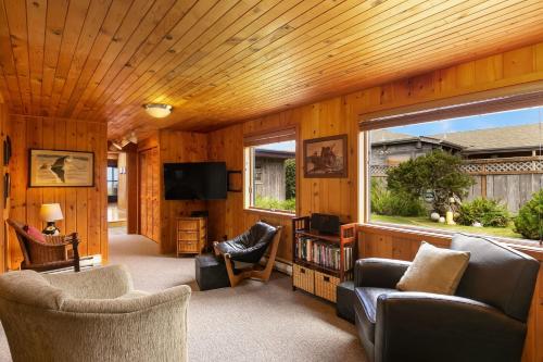 a living room filled with furniture and a large window at The Pilot House by AvantStay Stunning Home Right On Arch Cape Beach in Arch Cape