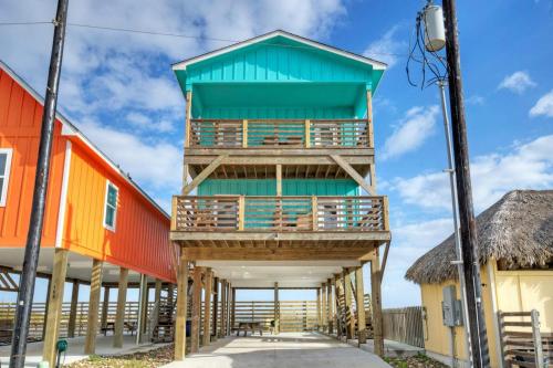 a building on the beach with colorful houses at Waterfront w Bay Views Shared Pool Boat Dock Marlin Madness by AvantStay in Padre Island
