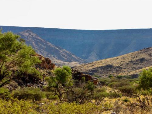 a view of a valley with mountains in the background at Mount Canyon Guest Farm in Keetmanshoop