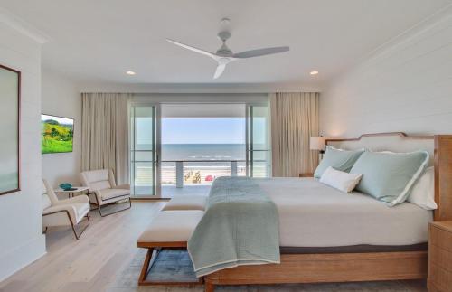 a bedroom with a bed with a view of the ocean at 710 Ocean Boulevard AvantStay Oceanfront Private Pool Rooftop Deck in Mount Pleasant