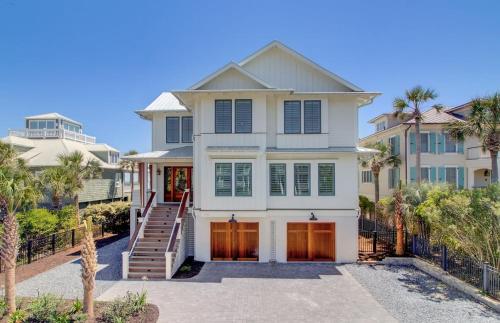 a large white house with a staircase in front of it at 710 Ocean Boulevard AvantStay Oceanfront Private Pool Rooftop Deck in Mount Pleasant