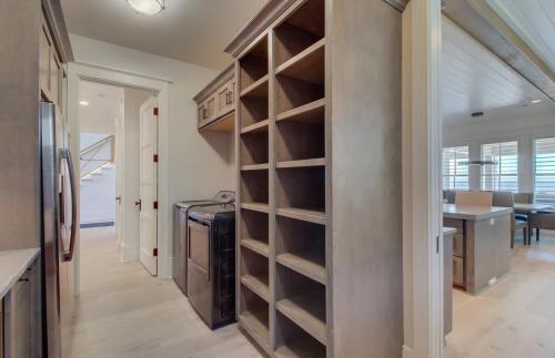 a kitchen with a built in pantry and a dining room at 710 Ocean Boulevard AvantStay Oceanfront Private Pool Rooftop Deck in Mount Pleasant