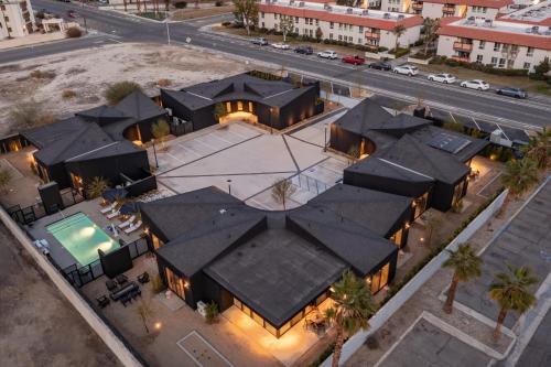 an aerial view of a house with black roofs at Blackhaus Full Buyout by AvantStay 16-Room Hotel in Palm Springs