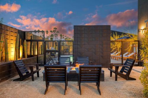 a rendering of a house with chairs and a table at Blackhaus Full Buyout by AvantStay 16-Room Hotel in Palm Springs