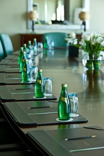 a long table with green bottles and glasses on it at Sofitel Al Khobar The Corniche in Al Khobar
