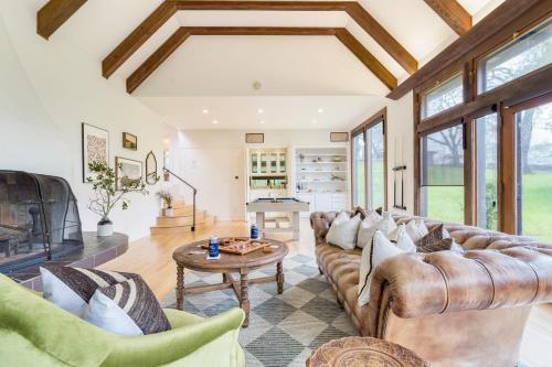 a living room with a couch and a table at Malvasia by AvantStay Luxe Wine Country Retreat in Santa Rosa