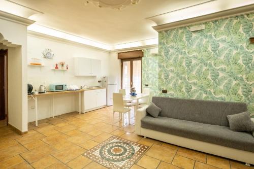 a living room with a couch and a kitchen at MG Luxury Home in Naples