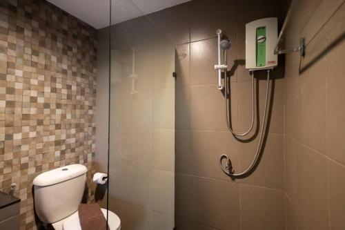 a bathroom with a shower stall with a toilet at Nature Boutique Residence in Bangkok