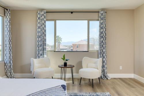 a bedroom with a bed and two chairs and a window at Desert Eden by AvantStay 6BR w Ensuite Backyard Oasis w Pool Hot Tub in Coachella