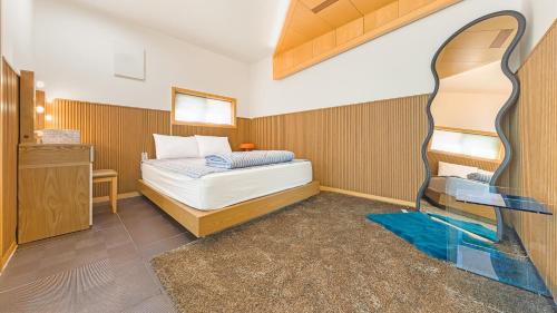 a bedroom with a bed and a fish tank in it at Gapyeong Rondavill Pension in Gapyeong