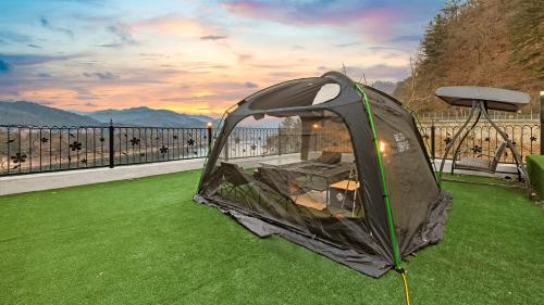 a tent sitting on the grass on a balcony at Gapyeong Rondavill Pension in Gapyeong