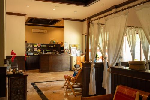 a living room with a counter and curtains at Lanta Sand Resort & Spa in Ko Lanta