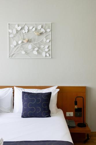 a bedroom with a bed and a picture on the wall at Nature Boutique Residence in Bangkok