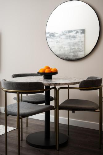 a table and two chairs and a mirror at Luxury Furnished Apartments by Hyatus Downtown at Yale in New Haven