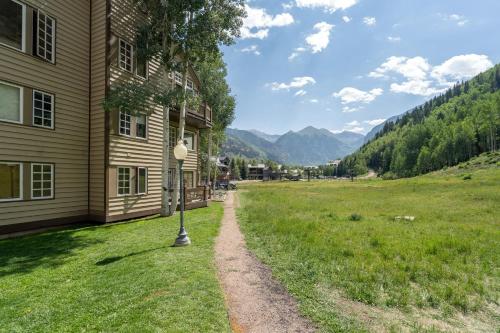 a dirt road next to a house in a field at Etta Place 1 by AvantStay Ski In Ski Out Unit w Views of the Slopes in Telluride
