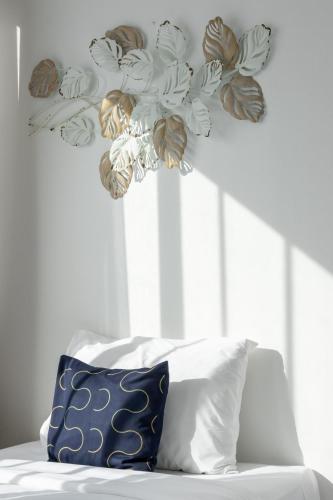 a room with a bed and a chandelier with flowers at Nature Boutique Residence in Bangkok
