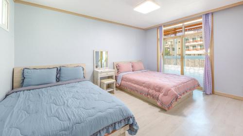 En eller flere senge i et værelse på Goseong Gamnamu Pension