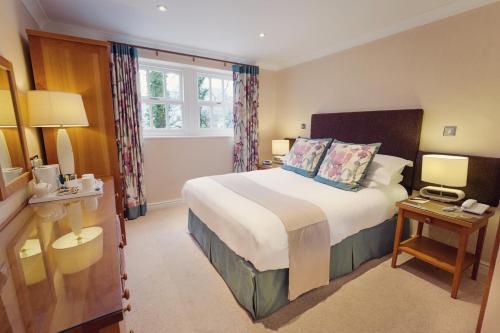 a hotel room with a large bed and a window at Briery Wood Hotel in Ambleside