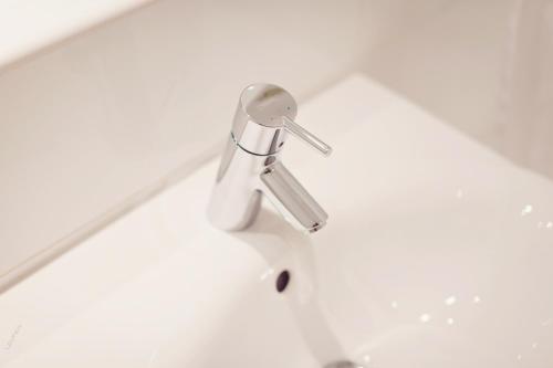 a bathroom sink with a faucet on top of it at Briery Wood Hotel in Ambleside