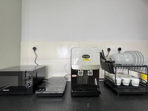 a coffee maker sitting on top of a kitchen counter at RiverView 8PAX 2BR in KBtown Wi-Fi, A-1-6 in Kota Bharu