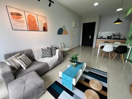 a living room with a couch and a table at RiverView 8PAX 2BR in KBtown Wi-Fi, A-1-6 in Kota Bharu