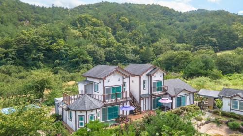 an aerial view of a house on the hill at Samcheok Herb Pension in Samcheok