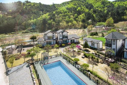 an aerial view of a house with a swimming pool at Samcheok Herb Pension in Samcheok