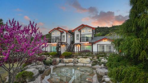 a large house with a pond in the yard at Samcheok Herb Pension in Samcheok