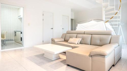 a living room with a couch and a table at GYEONGJU LINEVIEW POOLVILLA in Gyeongju