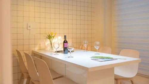 a table with a bottle of wine and wine glasses at GYEONGJU LINEVIEW POOLVILLA in Gyeongju