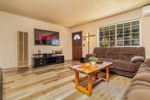 a living room with a couch and a table at Giraffe House in Chula Vista