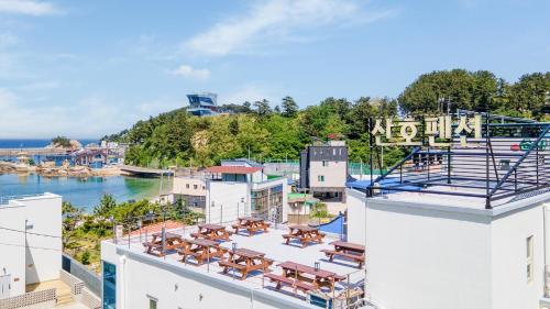 a view from the rooftop of a building with tables and chairs at Samcheok jangho sanho Pension in Samcheok