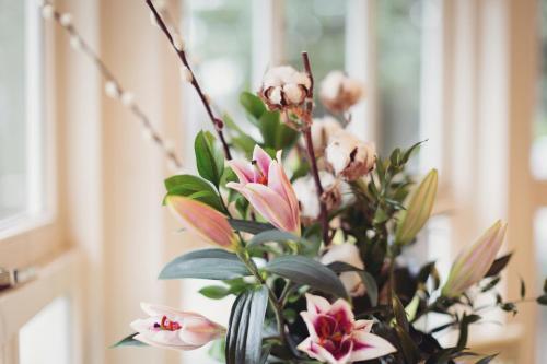 a vase filled with pink flowers on a table at Briery Wood Hotel in Ambleside