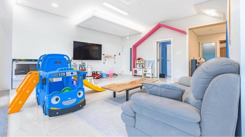 a living room with a couch and a play equipment at Gyeongju cheongun28 kids Poolvilla in Gyeongju