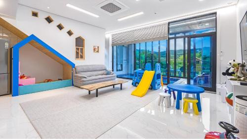 a living room with a couch and a slide at Gyeongju cheongun28 kids Poolvilla in Gyeongju