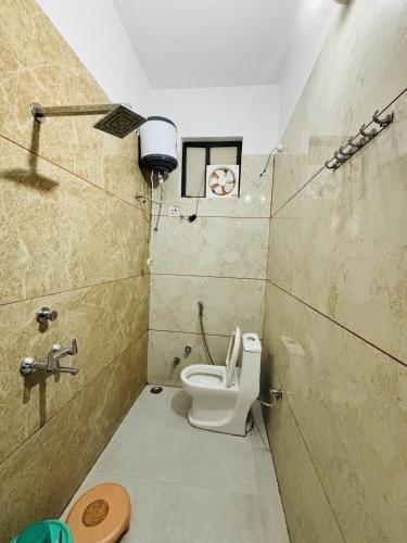 a bathroom with a toilet and a sink at Hotel Mother land near ganga ghat in Haridwār