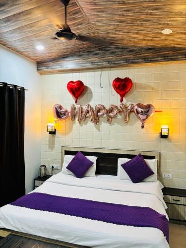 a bedroom with a bed with hearts on the wall at Hotel Mother land near ganga ghat in Haridwār