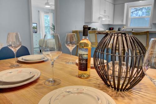 a bottle of wine sitting on a table with glasses at Ion by AvantStay Walk to Beach Dining Shopping Central Location Deck in Sullivans Island