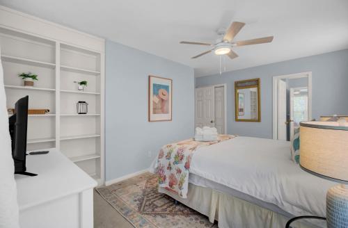 a bedroom with a bed and a ceiling fan at Ion by AvantStay Walk to Beach Dining Shopping Central Location Deck in Sullivans Island