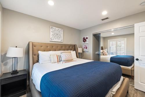 a bedroom with a large bed and a mirror at Breathtaking Meadows by AvantStay Temecula Group Retreat Pool Pickleball Firepit Hot Tub in Temecula