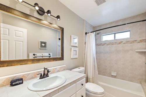 a bathroom with a sink and a toilet and a mirror at Breathtaking Meadows by AvantStay Temecula Group Retreat Pool Pickleball Firepit Hot Tub in Temecula